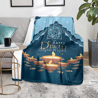 Blue Diwali festival blanket draped over chair, 'Happy Diwali' text and diya flames
