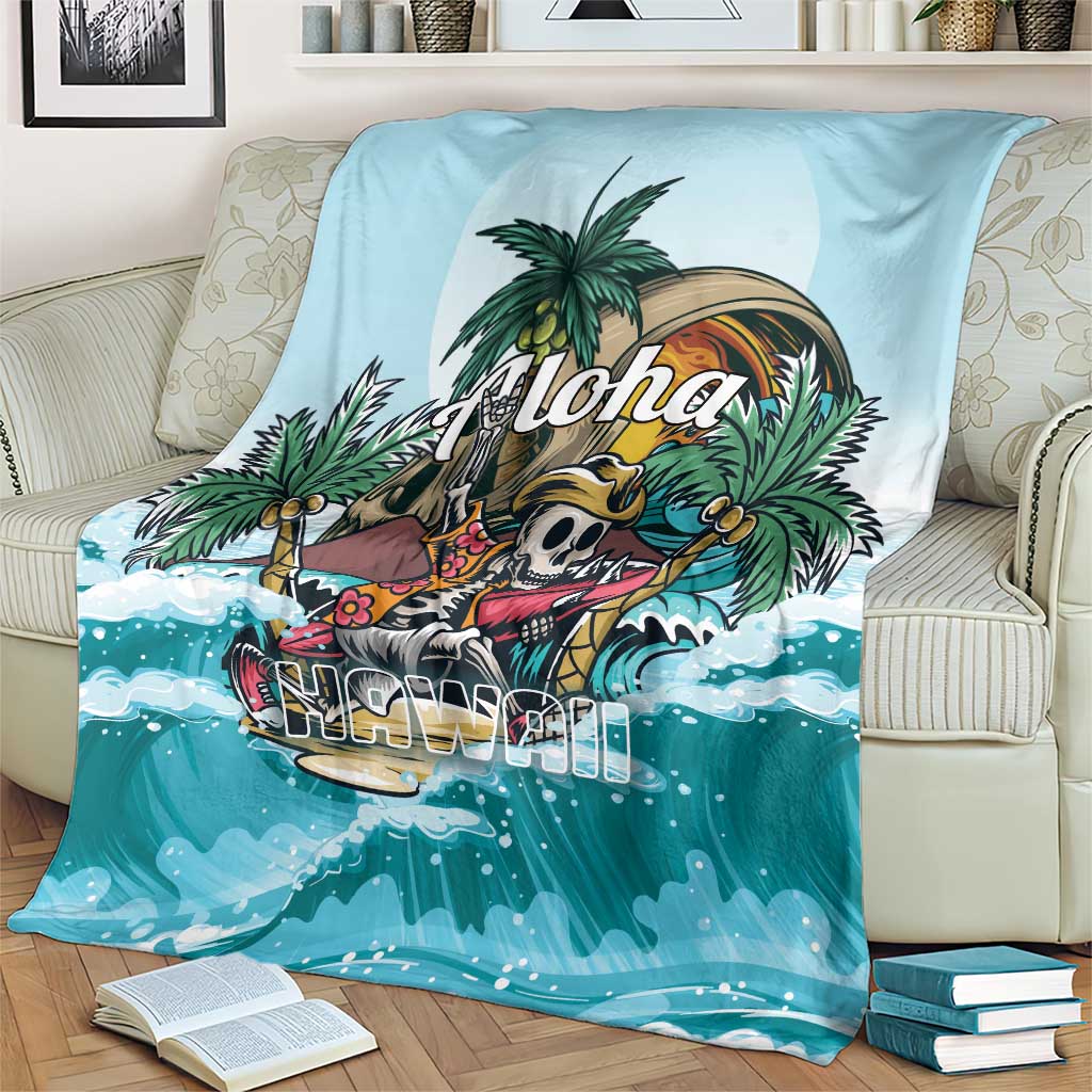 Blue tropical skeleton blanket on sofa with palm trees, 'Aloha' and ocean wave pattern