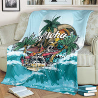 Blue tropical skeleton blanket on sofa with palm trees, 'Aloha' and ocean wave pattern