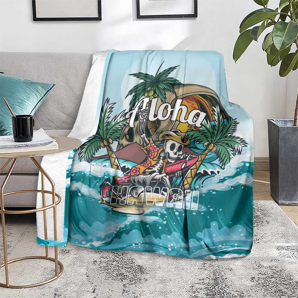 Blue tropical skeleton throw blanket with 'Aloha' graphic and swirling ocean waves