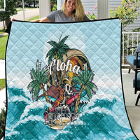 Blue quilt with diamond stitching and tropical “Aloha” graphic over ocean waves