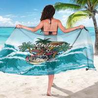 Blue tropical sarong draped wide with Aloha graphic, palm leaves, skull and waves