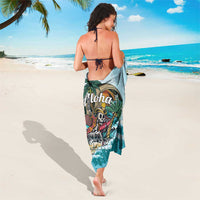 Blue tropical sarong with Aloha logo and skull wave print, tied at sides