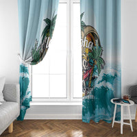 Light blue curtain panels with tropical aloha skull and wave border near the bottom