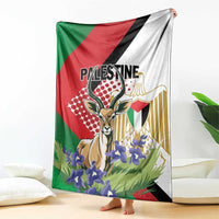Palestine blanket draped with gazelle emblem and purple flowers, red green black white