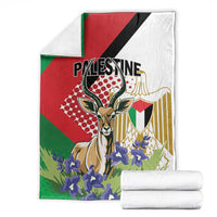 Palestine blanket with folded white rolls, gazelle artwork and purple flowers