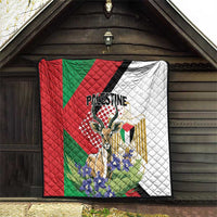 Palestine quilt blanket hanging in doorway, red and green panels with white quilted section