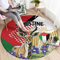 Round area rug featuring gazelle and Palestine lettering, red green and blue illustrated design