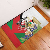 Square rubber doormat on hardwood floor, Palestine Gazelle illustration in red and green