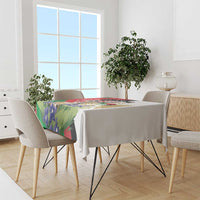 Printed tablecloth on dining table with colorful gazelle and floral Palestine design.