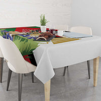 Tablecloth draped over dining table edge; multicolor gazelle and flag-style artwork.
