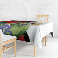 Colorful printed tablecloth with gazelle and Palestine-style pattern, draped over bench.