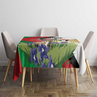 Square tablecloth with bold gazelle and floral Palestine graphic on dining table.