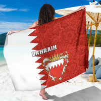 Red sarong with Bahrain coat-of-arms crest, floral pattern, and white zigzag trim
