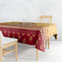 Christmas tablecloth draped on dining table, gold and red geometric holiday pattern