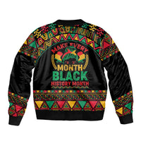 Black unisex bomber jacket, colorful African graphic text on back, ribbed hem