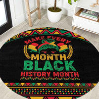 Round black rug with colorful African border and text 'Make Every Month Black History Month'
