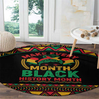 Round black rug with central 'MONTH BLACK HISTORY MONTH' design and green, red, yellow trim