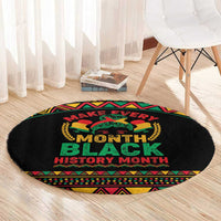 Round black rug with 'Make Every Month Black History Month' text and colorful geometric border
