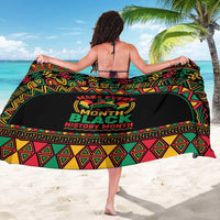 Multicolor African-pattern sarong with central circular 'Black History Month' emblem