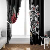 Black curtain panels with white tribal mask print and red hibiscus accents by a window