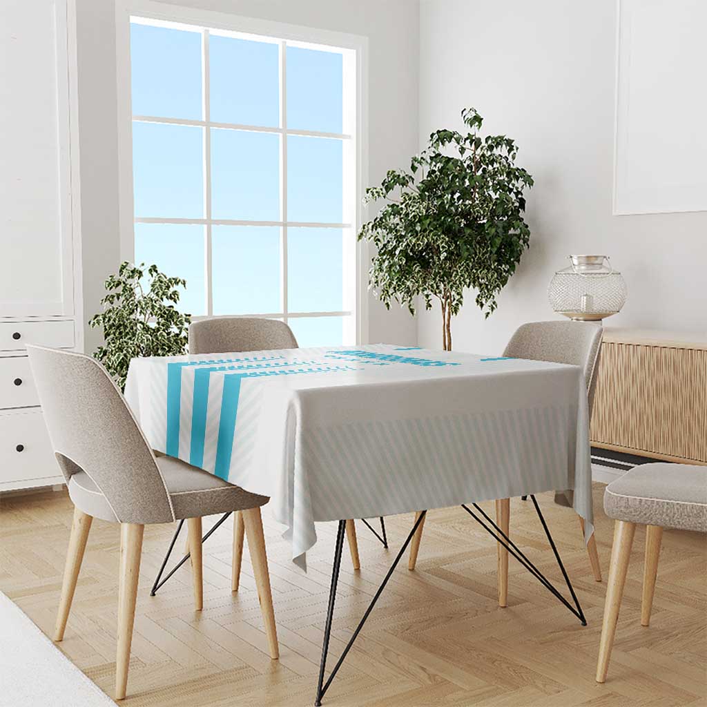 Blue striped tablecloth draped on dining table with chairs