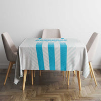 Blue striped tablecloth on square dining table with four chairs