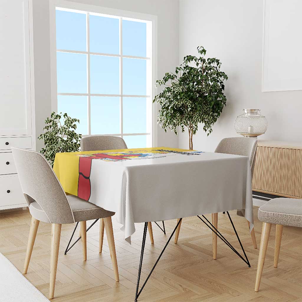 Yellow tablecloth with colorful rectangular graphic panel on round dining table.