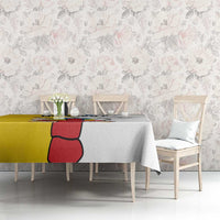 Gray and yellow tablecloth with red figure graphic on dining table in front room.