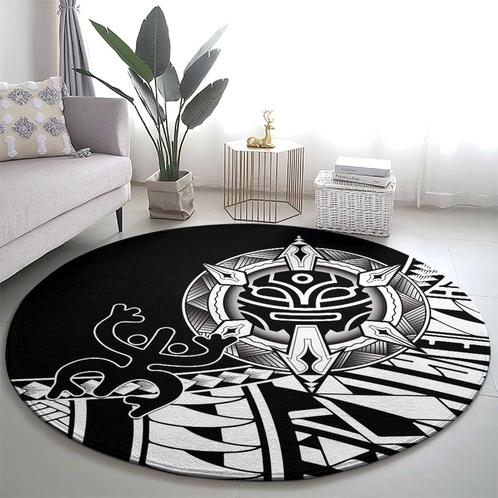 Black round area rug with white Polynesian tribal crest and bold symmetrical shapes
