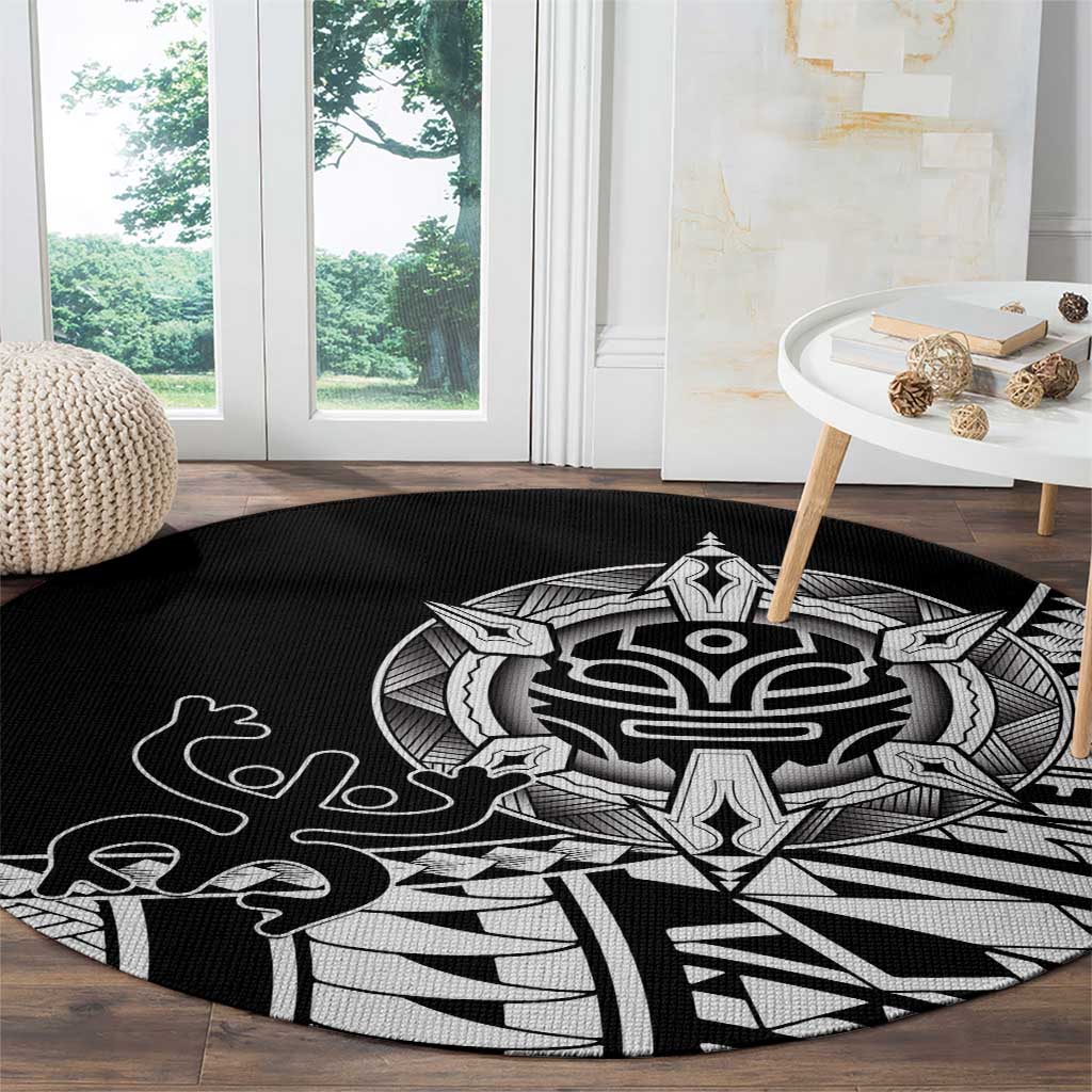 Black round area rug with white tribal mask center and jagged geometric rays