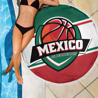 Round beach blanket with Mexico Guerreros basketball logo over poolside tiles, fringed edge