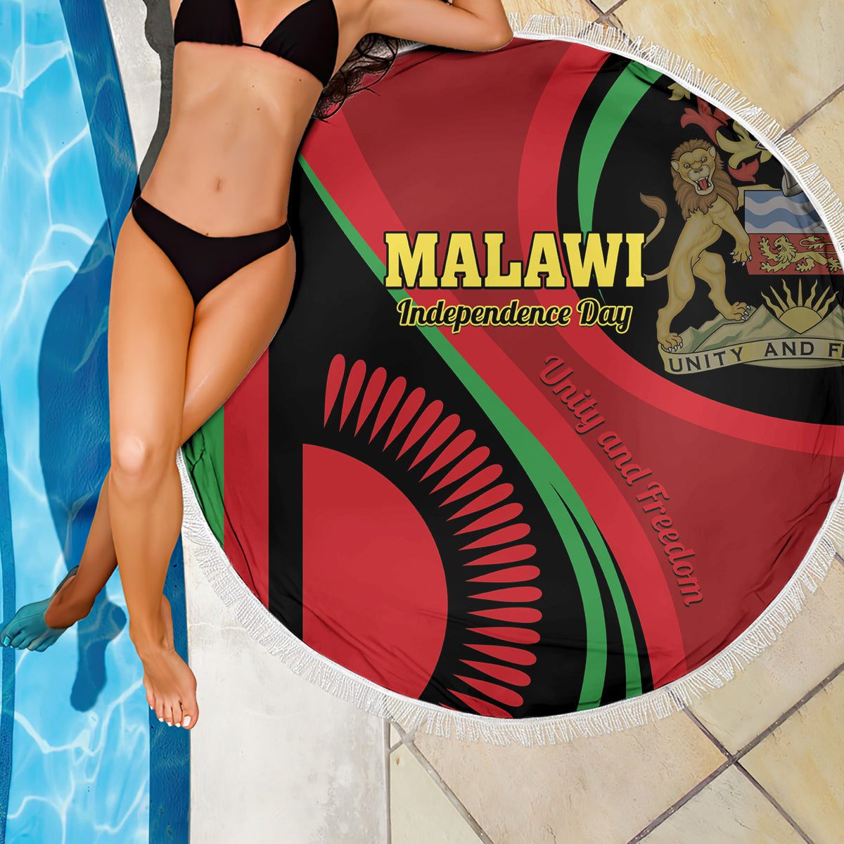 Round beach blanket with Malawi Independence Day design and white fringe, draped in poolside scene