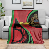 Malawi Independence Day blanket on sofa, red/green/black flag print with text and emblem