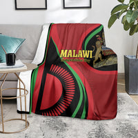 Malawi Independence Day blanket on chair, red/green/black flag graphic with Malawi lettering