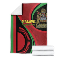 Malawi Independence Day blanket with red, green, black flag design; rolled white towels included