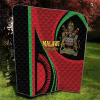 Black quilt blanket with red center and green side stripe, featuring a Malawi emblem
