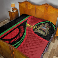 Red and black quilt with green stripe accents and Malawi emblem on a wooden bed