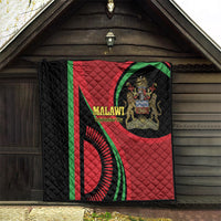 Black quilt with red and green Malawi flag-style emblem and quilted diamond stitching