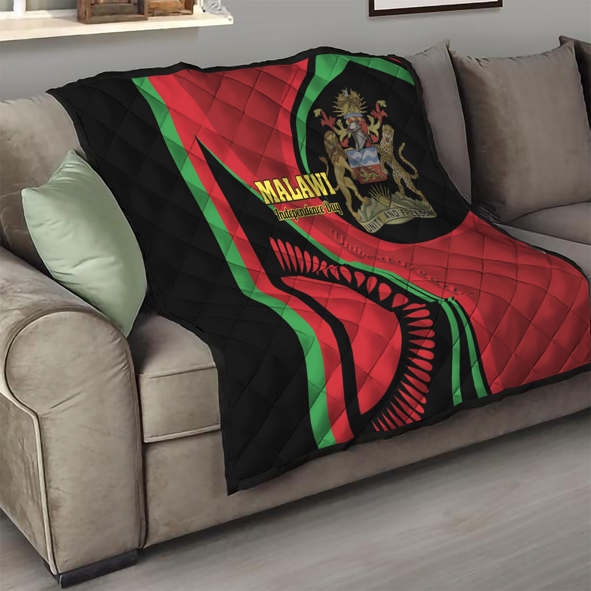 Folded black quilt with red and green Malawi emblem and quilted diamond texture
