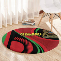 Round carpet in red, black, and green with Malawi Independence Day graphic