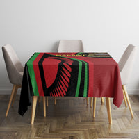 Black tablecloth with red and green striped Malawi Independence Day design on dining table