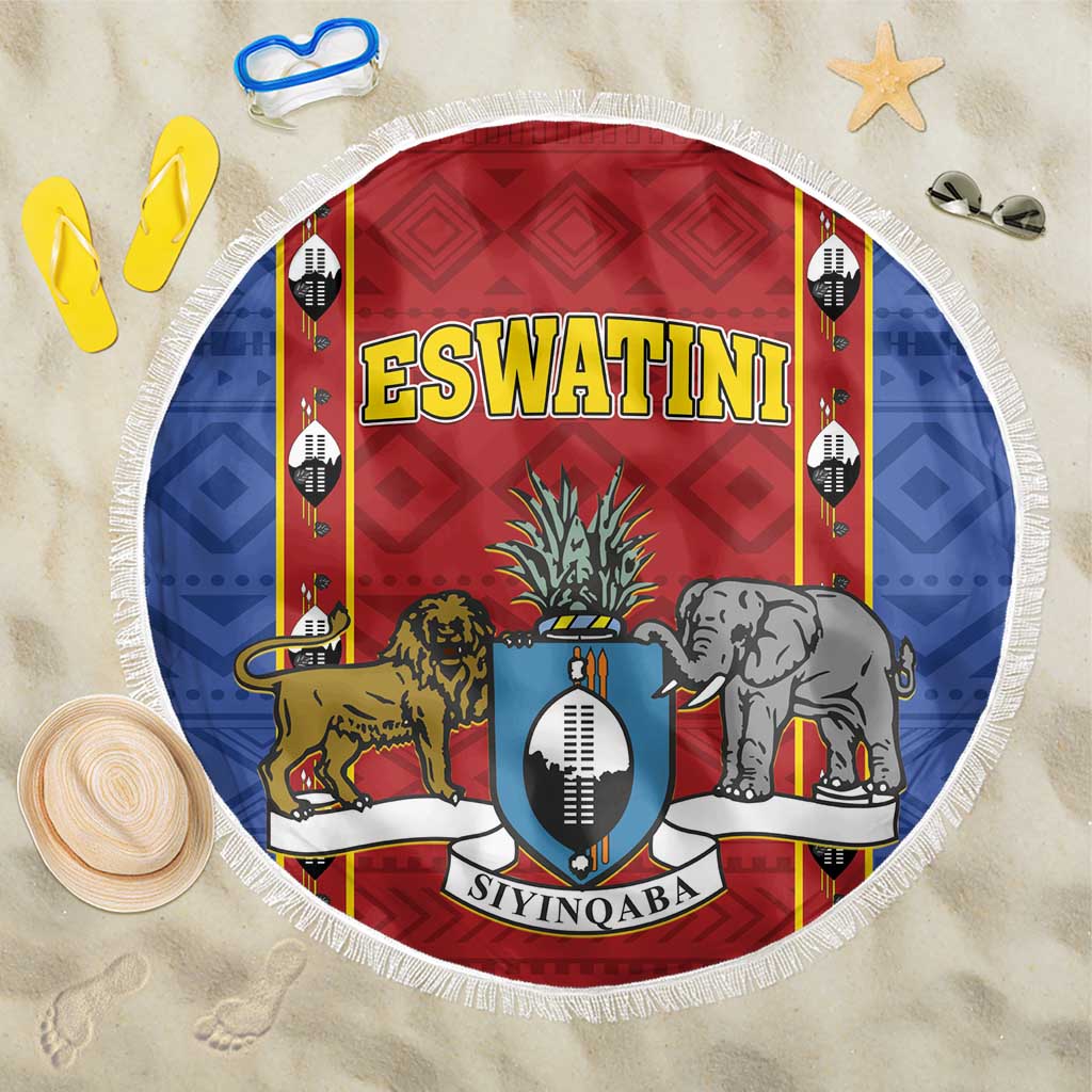 Round blue and red beach blanket with shield crest and tassel-fringe edge