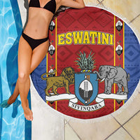 Round fringed beach blanket showing red and blue shield with elephant and lion figures