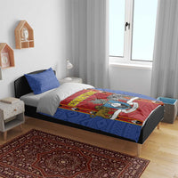 Blue bedding set on bed with red shield artwork and two blue patterned pillowcases