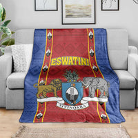 Blue and red African pattern blanket with shield crest graphics and animals