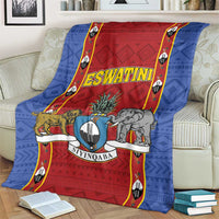 Blue and red Eswatini shield crest blanket draped on a sofa with animal illustrations