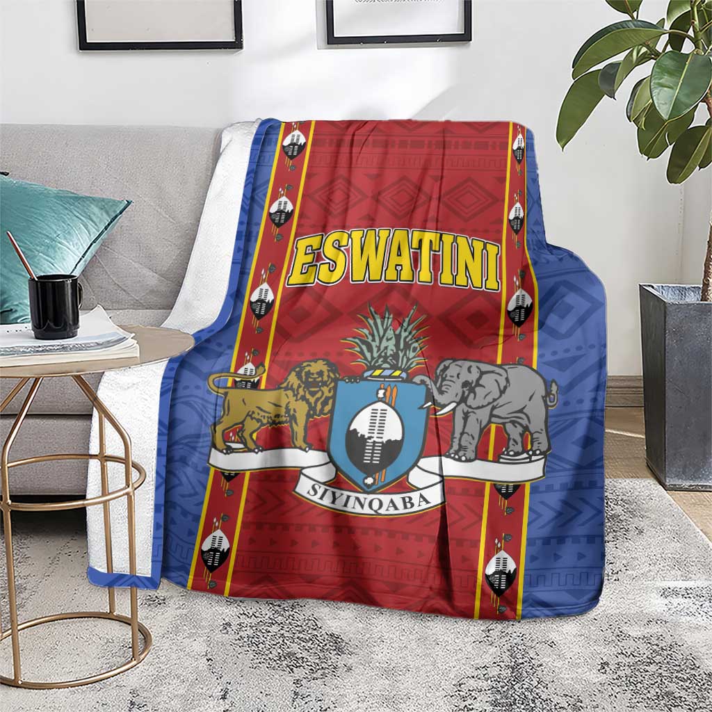 Blue and red blanket with Eswatini shield crest, animals, and bold border accents