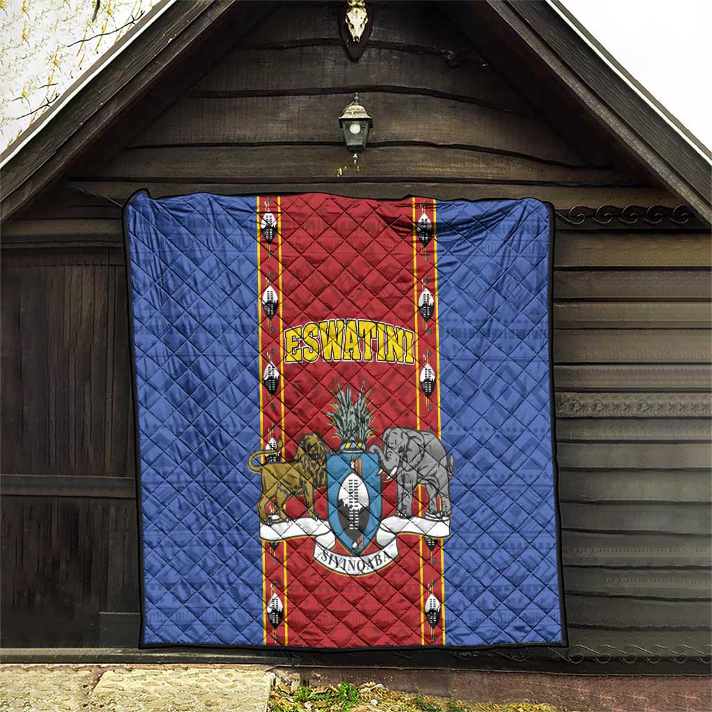 Blue quilt blanket with red center panel and ESWATINI shield graphic, hung in a doorway