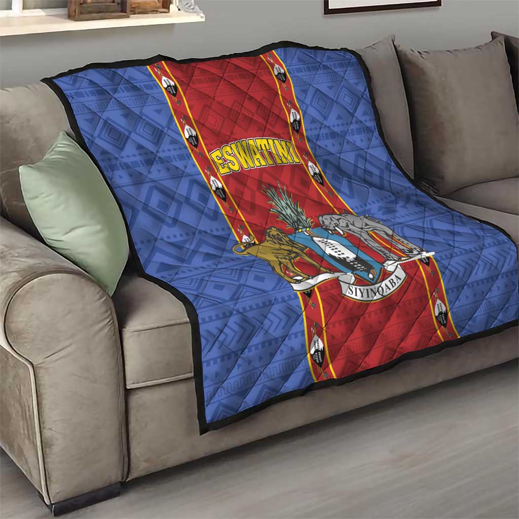 Blue quilt blanket with red center strip, ESWATINI title and animal shield print, on sofa